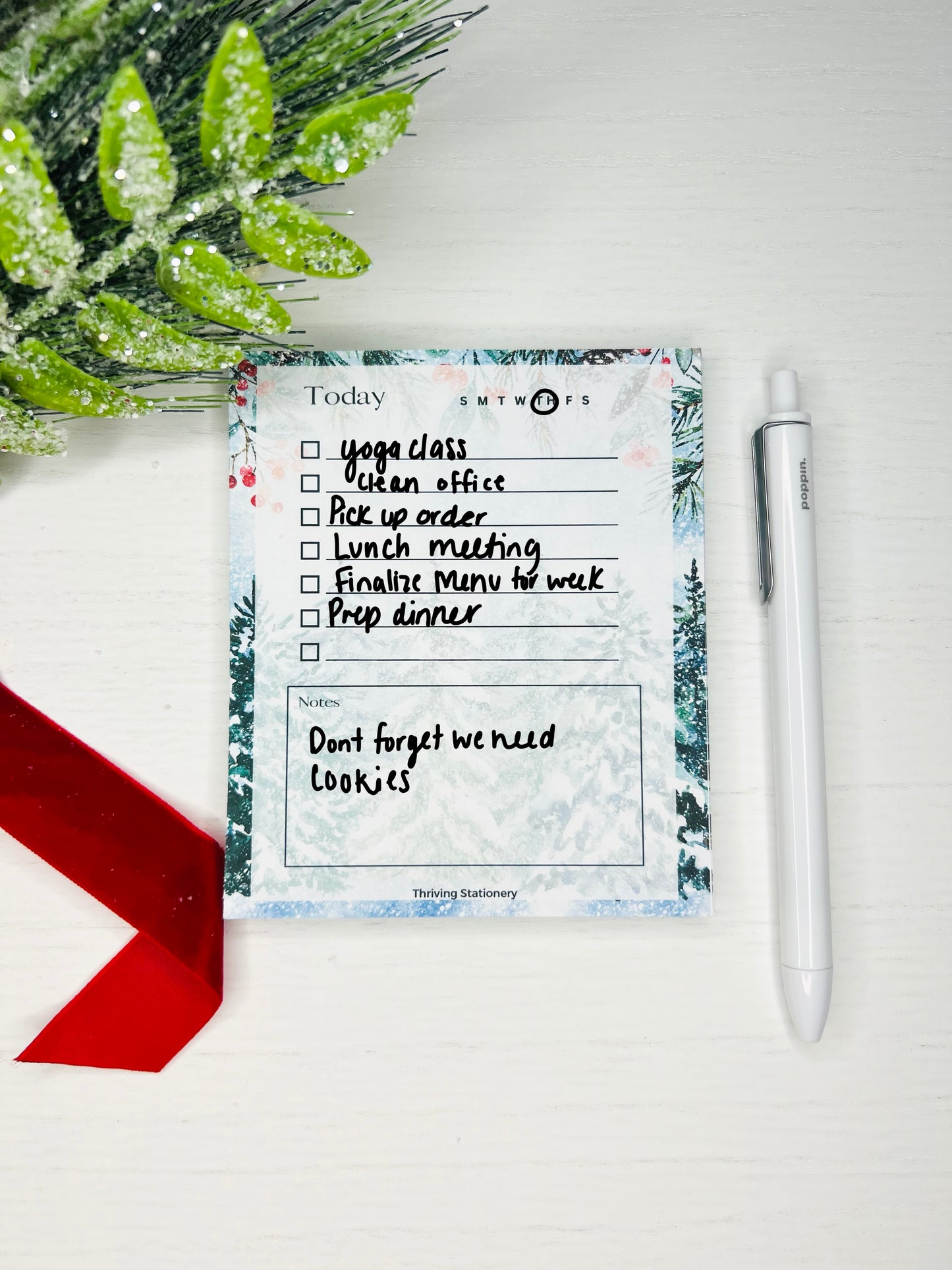A filled-in to-do list with a winter design, featuring frost-kissed tree illustrations and the title 'TODAY' at the top, along with a check box next to each page line.