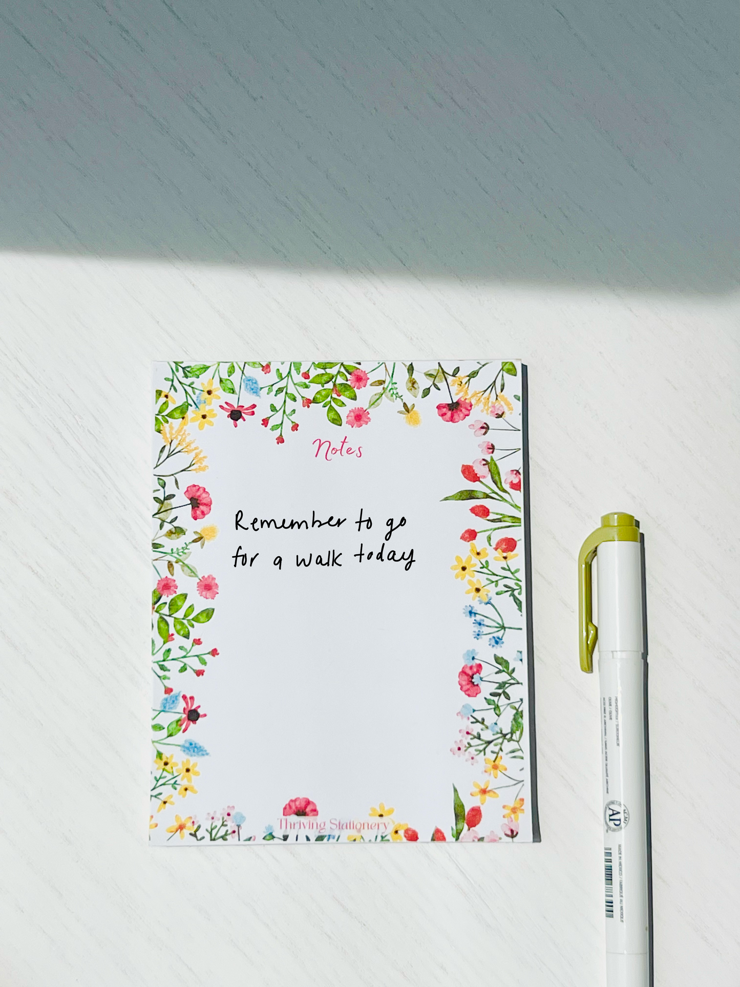 Blank notepad with vibrant floral border and 50 tear-away sheets, ideal for colorful notes, lists, and expressive planning.