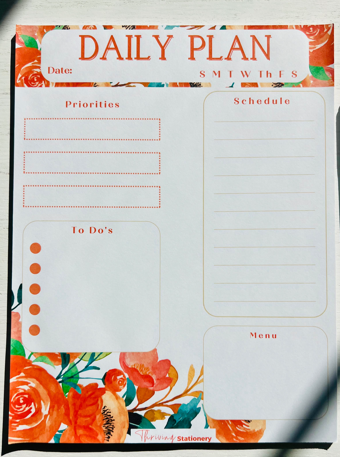 Daily planner notepad with undated pages and floral design