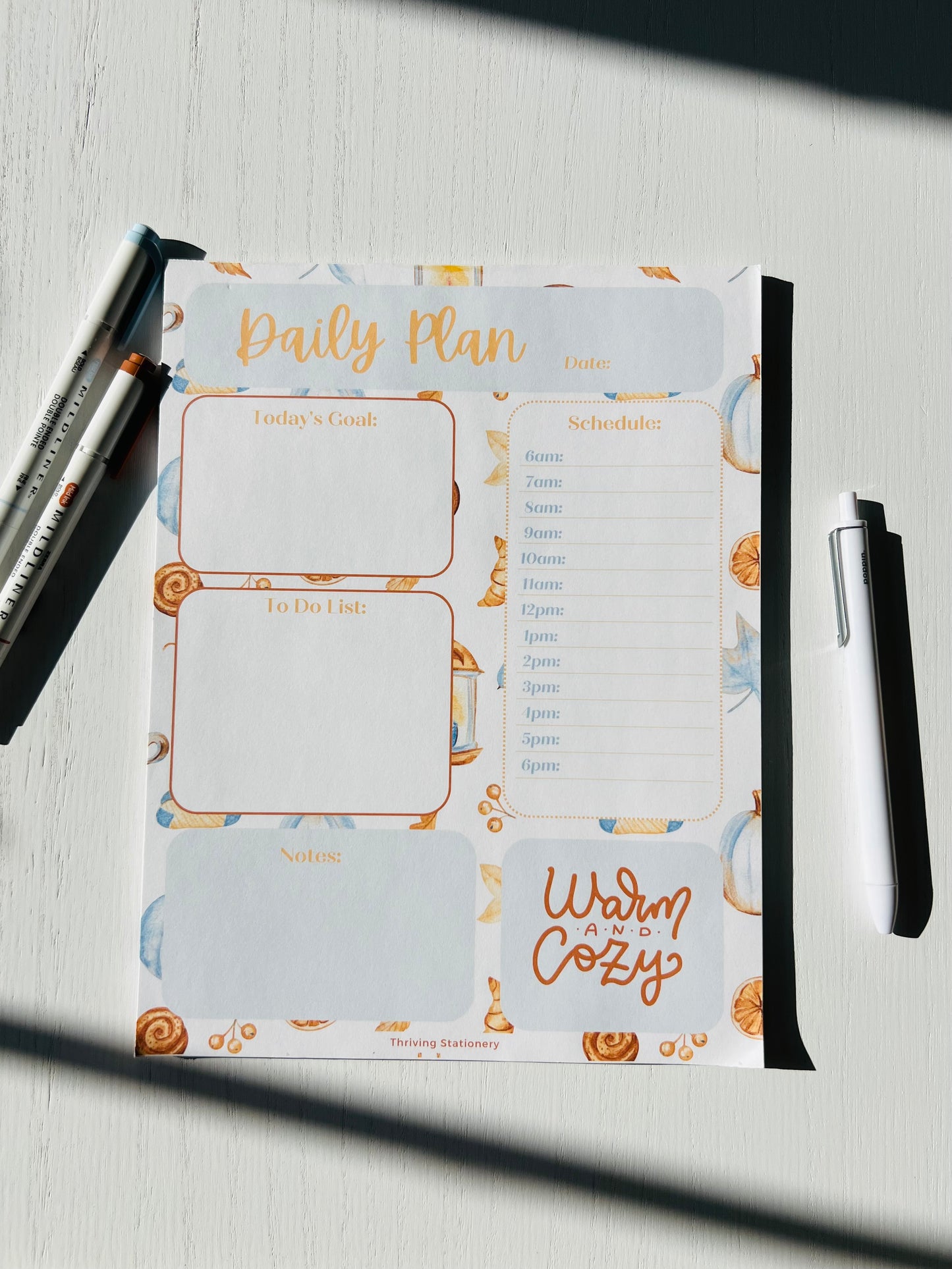 cozy fall stationery flat lay featuring daily planner