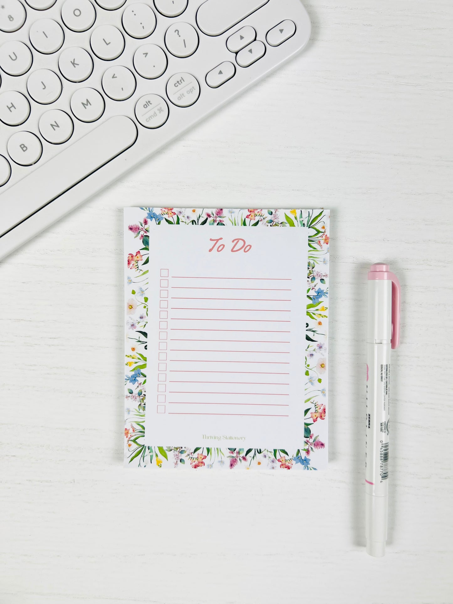 Tackle your day beautifully with the Floral To-Do List Notepad — a soft floral design made for daily tasks, checklists, and organized planning with a pen and keyboard for scale.