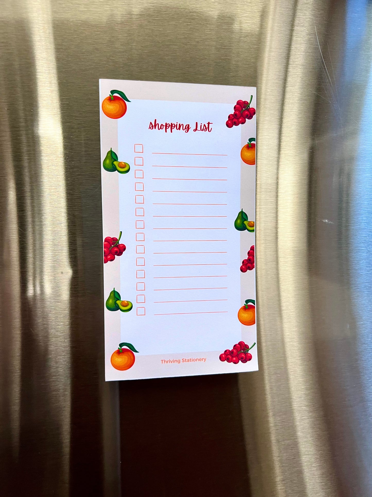 Fruit-themed magnetic shopping list notepad with oranges, pears, and berries, red checkboxes and tear-away sheets for groceries or to-dos.