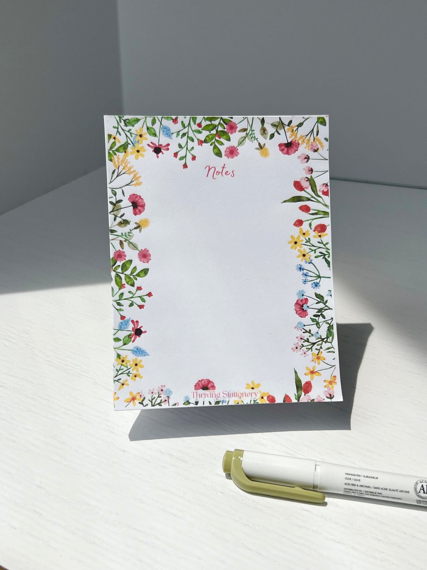 Blank notepad with vibrant floral border and 50 tear-away sheets, ideal for colorful notes, lists, and expressive planning.