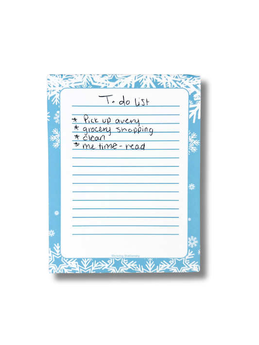 To-do list on a notepad with decorative border on a white background