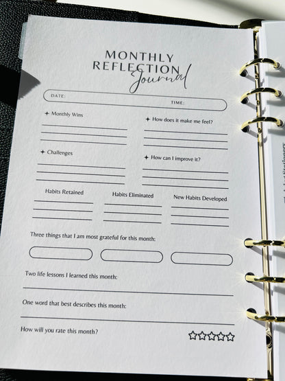Monthly Reflection Journal page in a planner with text and space for writing.