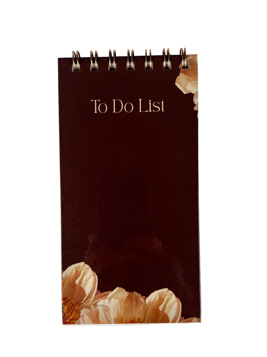 Notebook titled 'To Do List' with floral design on a white background