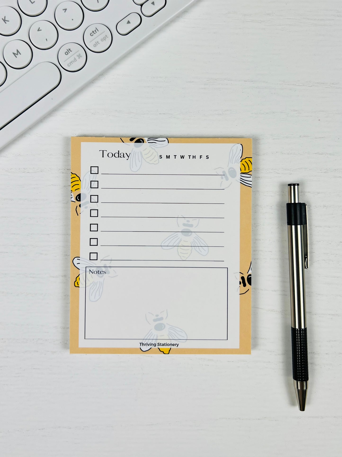Bee Productive To-Do List Notepad with yellow bee design and daily checklist layout with pen for scale