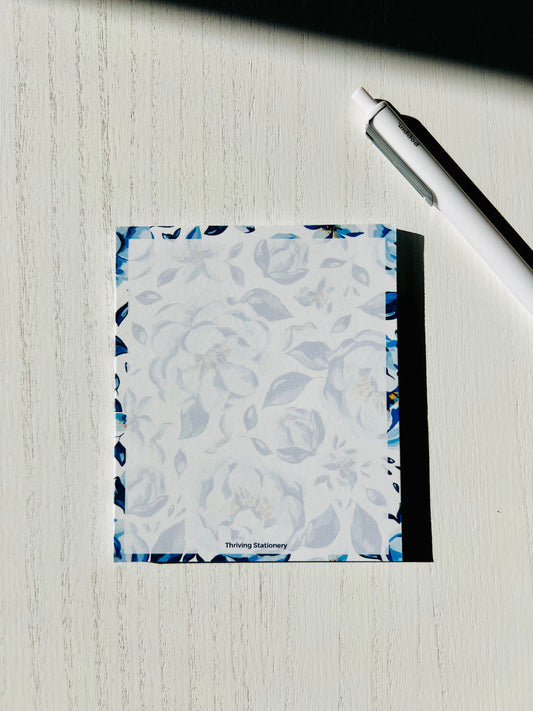 Blank notepad with soft blue floral border and 50 tear-away sheets, perfect for everyday notes, journaling, and peaceful planning.