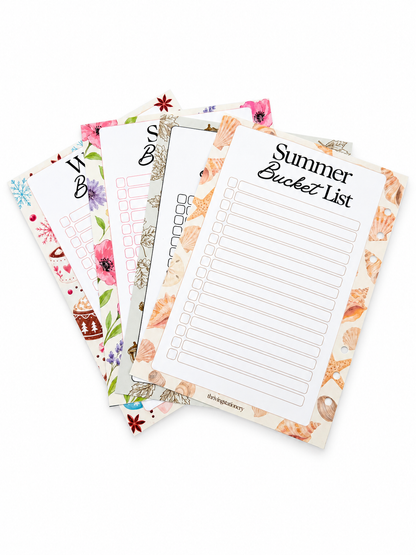 Four decorative printable list pads fanned out on a white background, including Summer Bucket List, 