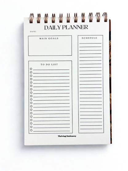 Daily planner with sections for main goals, schedule, to-do list, and date on a white background.