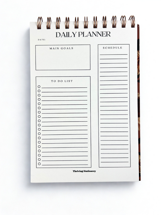 Daily planner with sections for main goals, schedule, to-do list, and date on a white background.