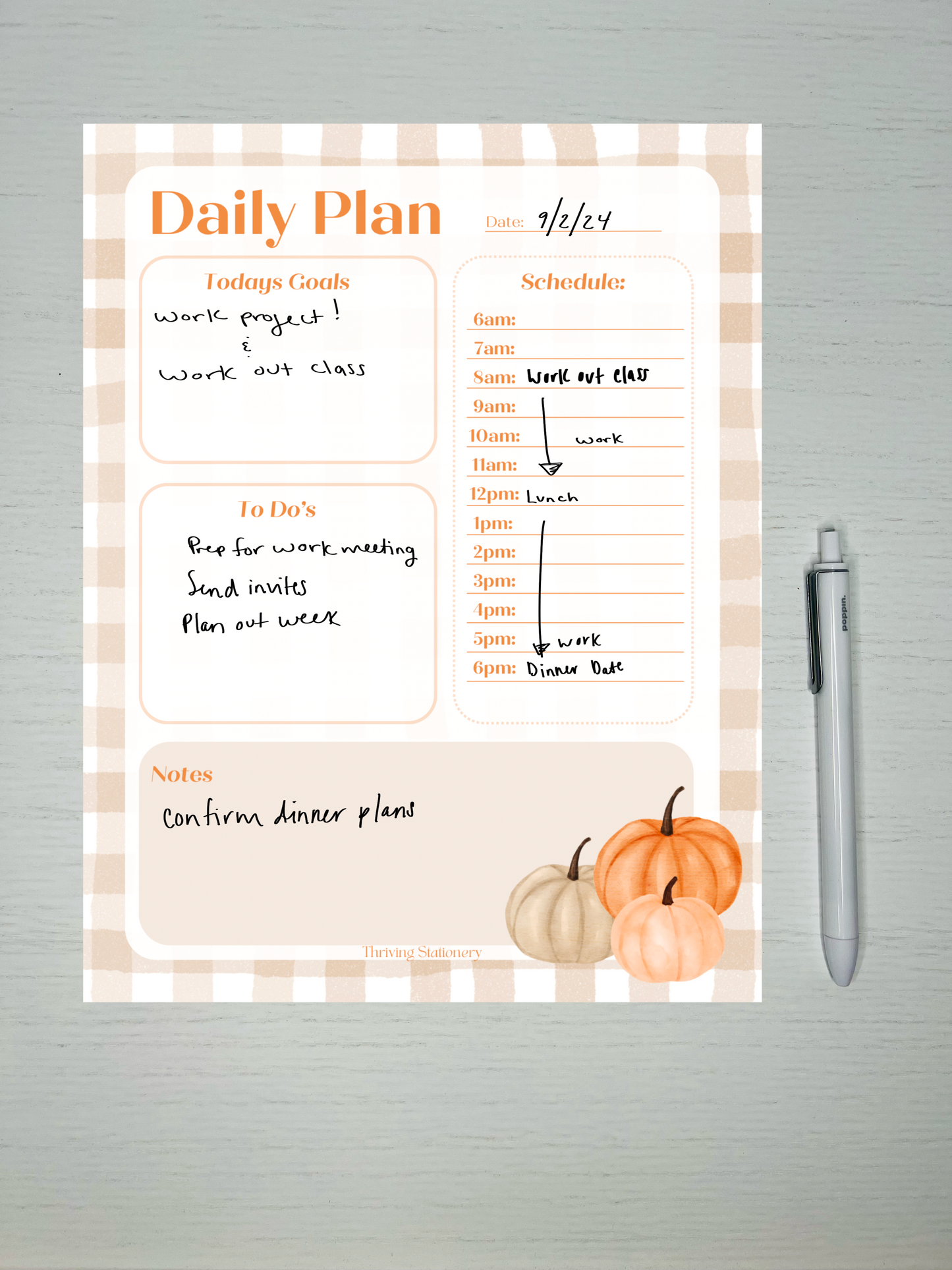 Fall-themed daily planner notepad with beige gingham border, pumpkins, time-stamped schedule, and sections for goals, to-do list, and notes.