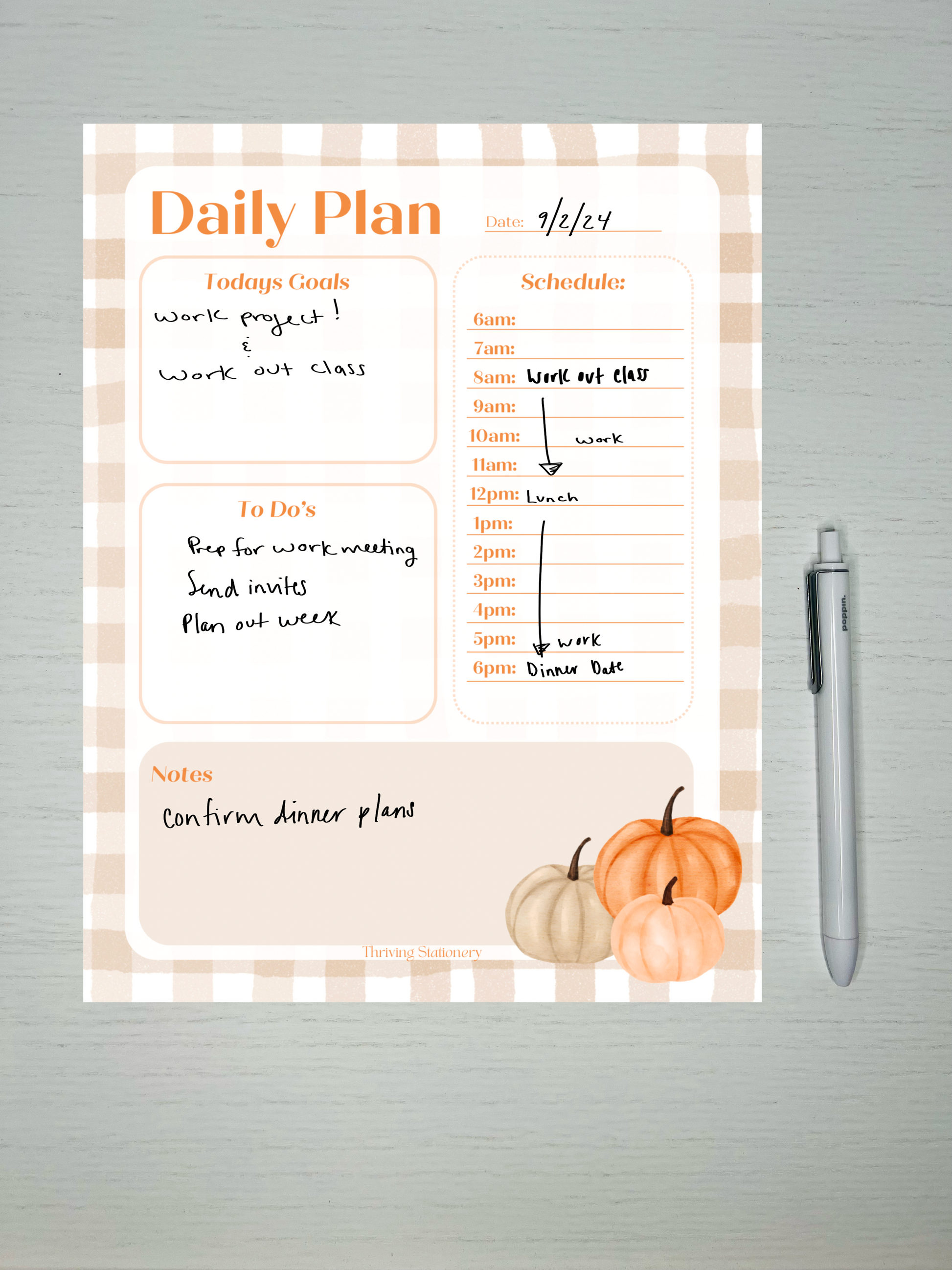 Fall-themed daily planner notepad with beige gingham border, pumpkins, time-stamped schedule, and sections for goals, to-do list, and notes.