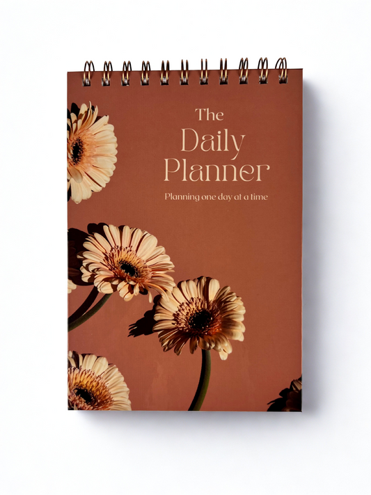 Daily planner with floral design on a brown background
