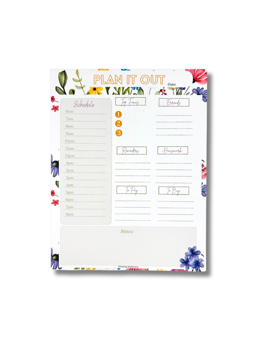 Floral planner pad with daily schedule and notes sections on a white background