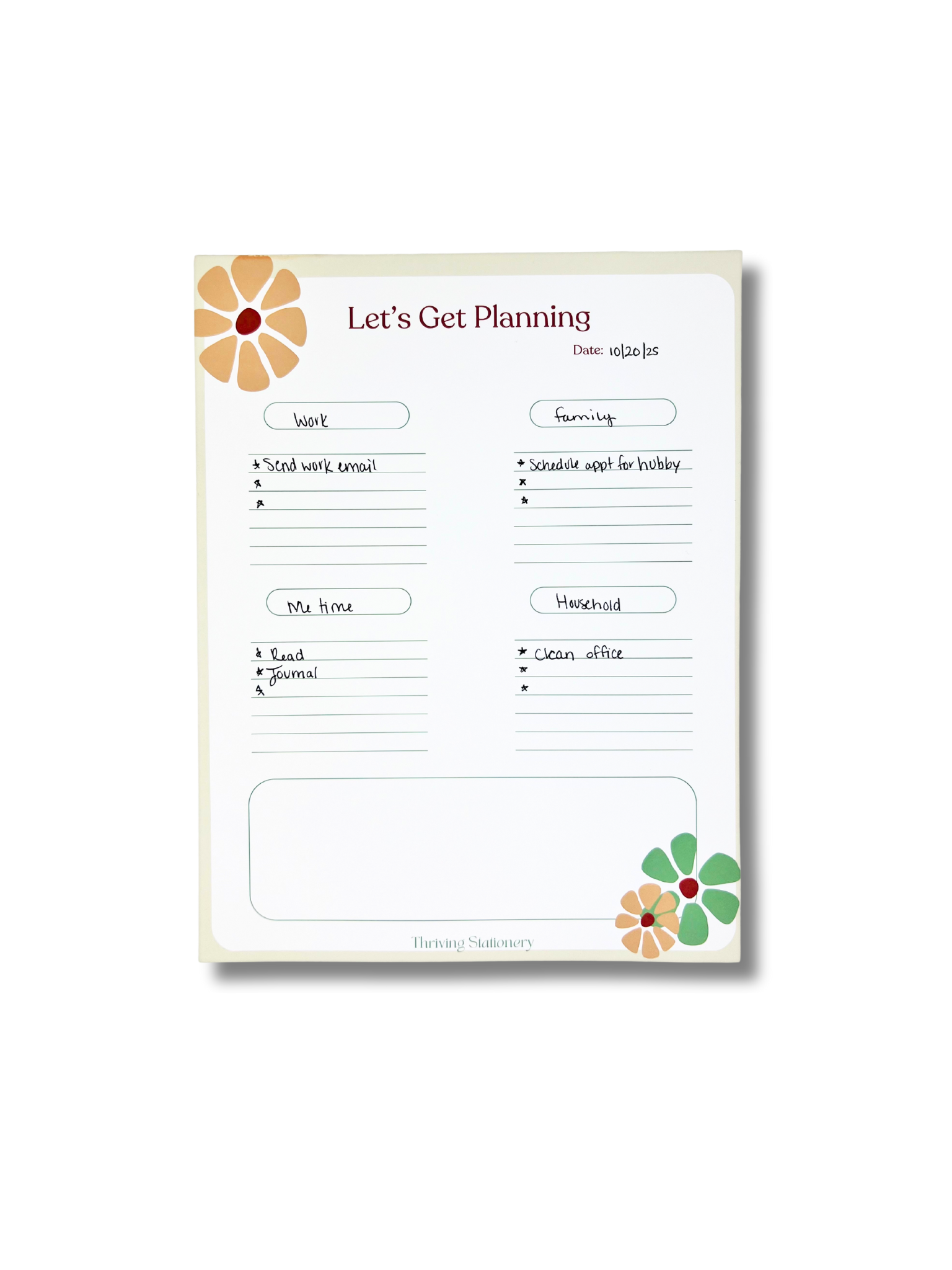 Planning notepad with floral designs on a white background