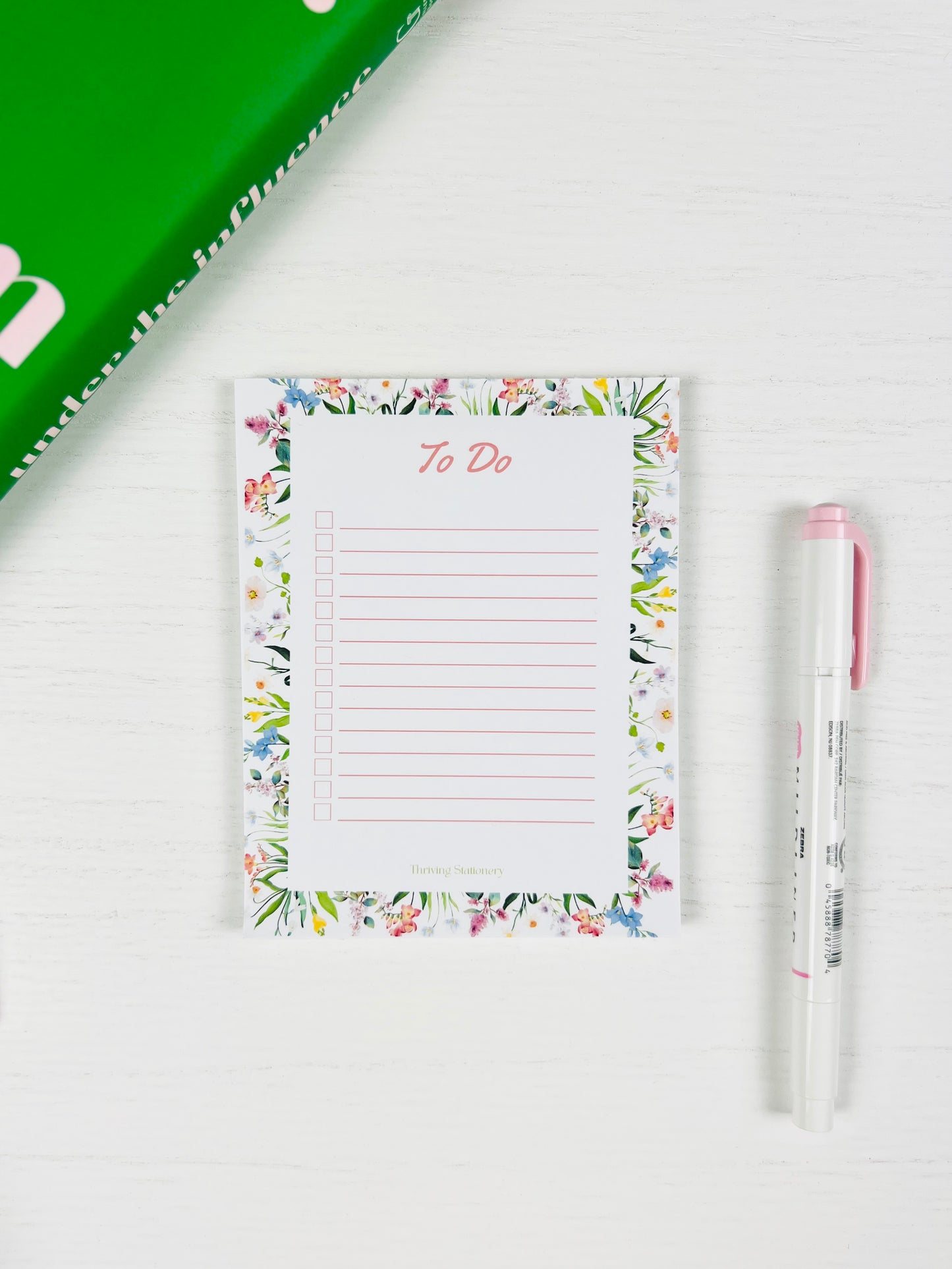 Tackle your day beautifully with the Floral To-Do List Notepad — a soft floral design made for daily tasks, checklists, and organized planning with a pen for scale 