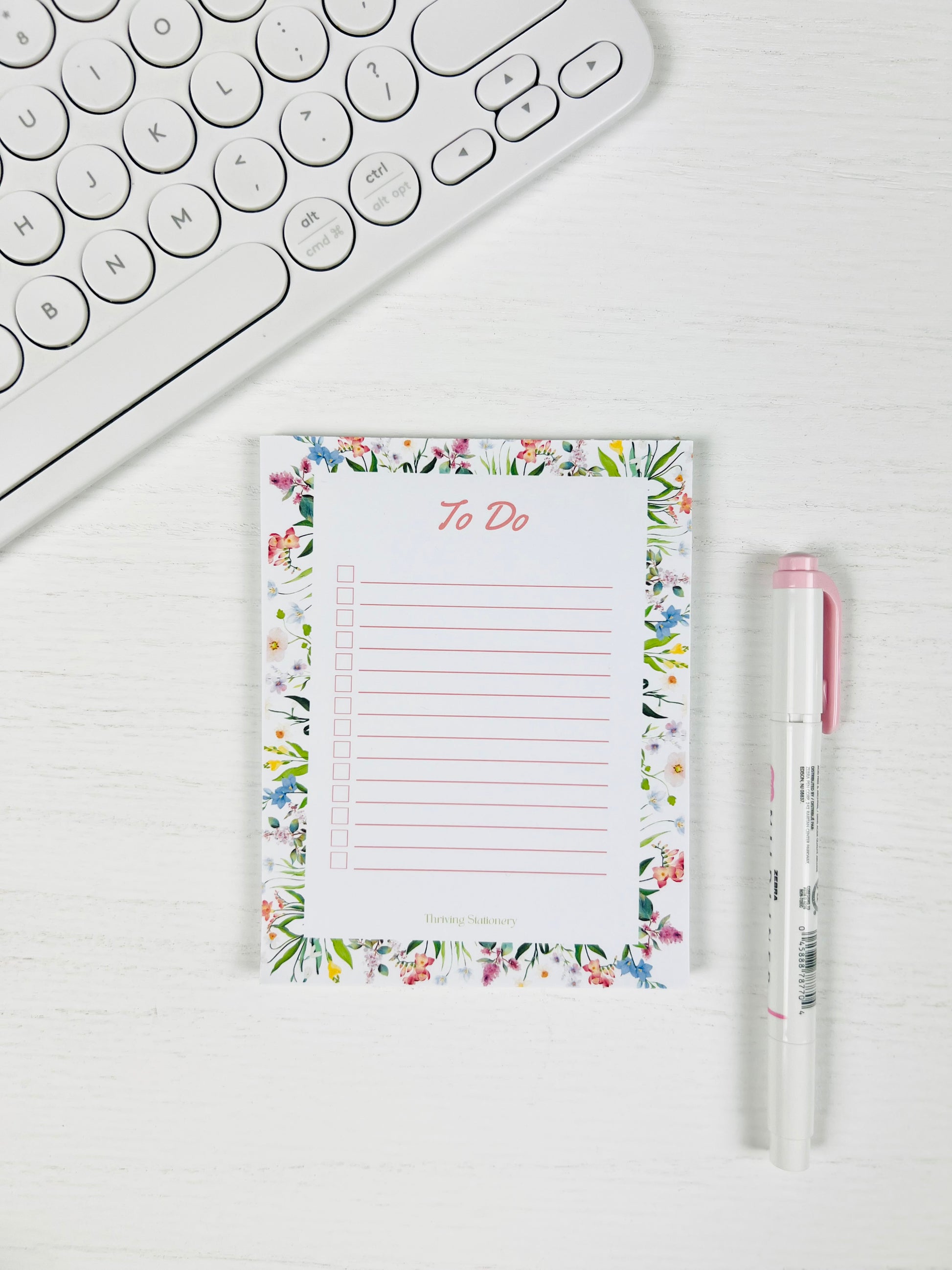 Tackle your day beautifully with the Floral To-Do List Notepad — a soft floral design made for daily tasks, checklists, and organized planning with a pen and keyboard for scale. 