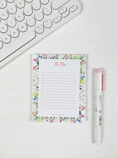 Tackle your day beautifully with the Floral To-Do List Notepad — a soft floral design made for daily tasks, checklists, and organized planning with a pen and keyboard for scale. 