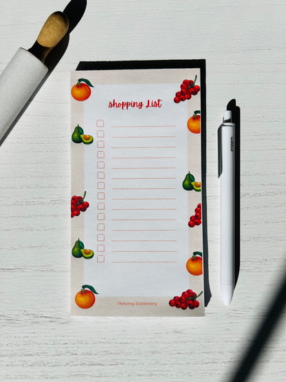 Fruit-themed magnetic shopping list notepad with oranges, pears, and berries, red checkboxes and tear-away sheets for groceries or to-dos.
