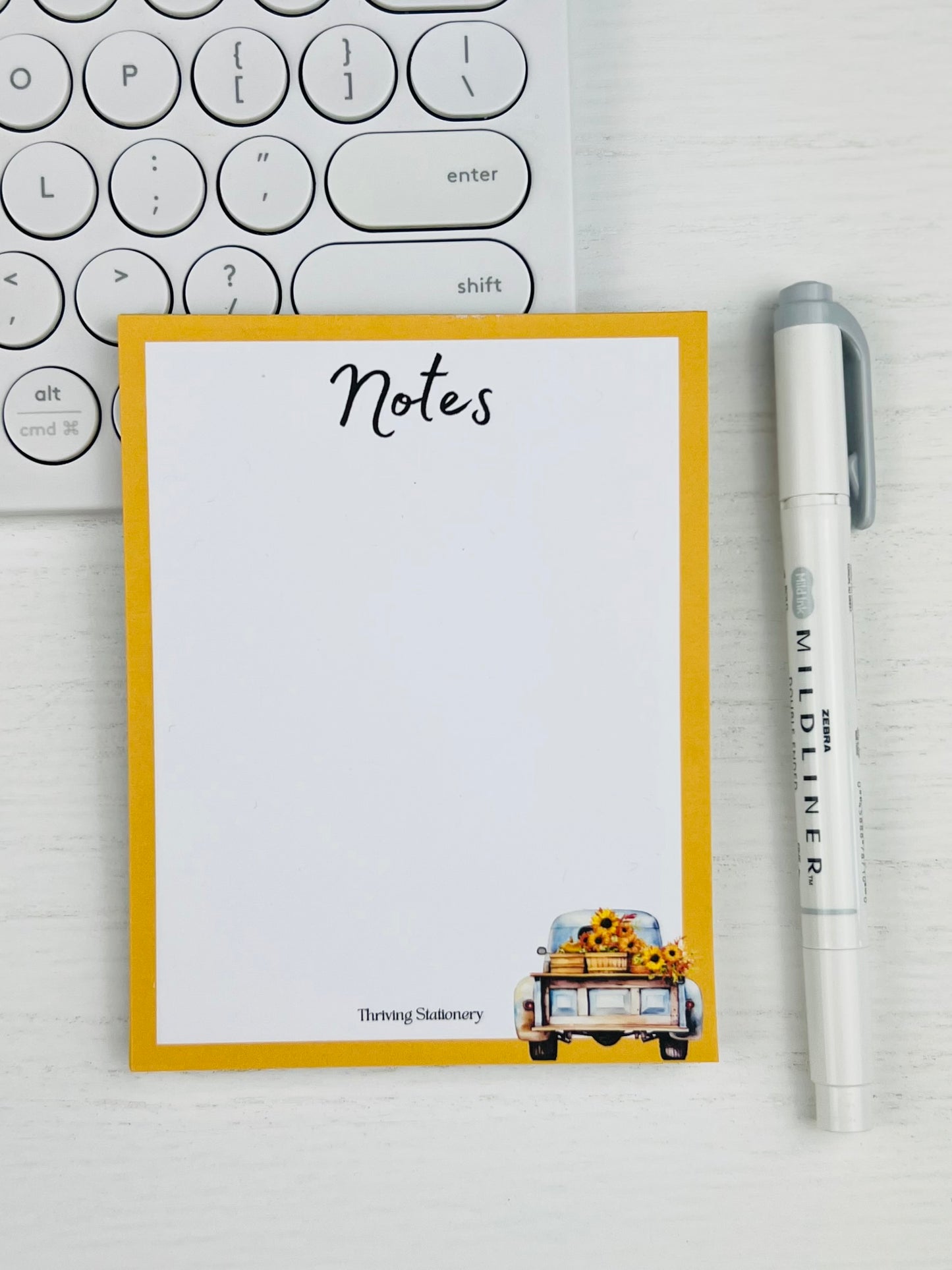 Golden Harvest Notepad with yellow border and vintage truck carrying sunflowers with pen and keyboard for scale