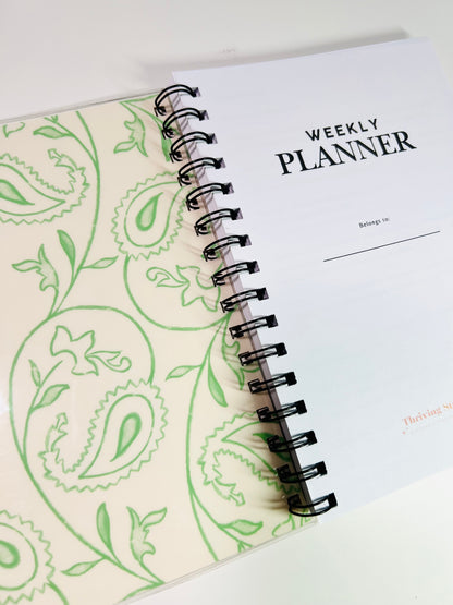 Weekly planner with paisley design on a white background