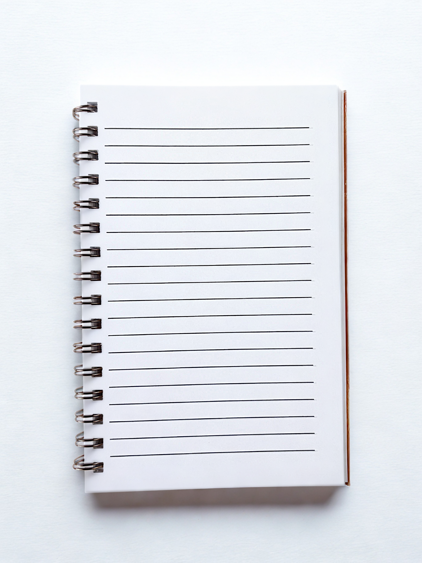White notebook with lined pages on a white background