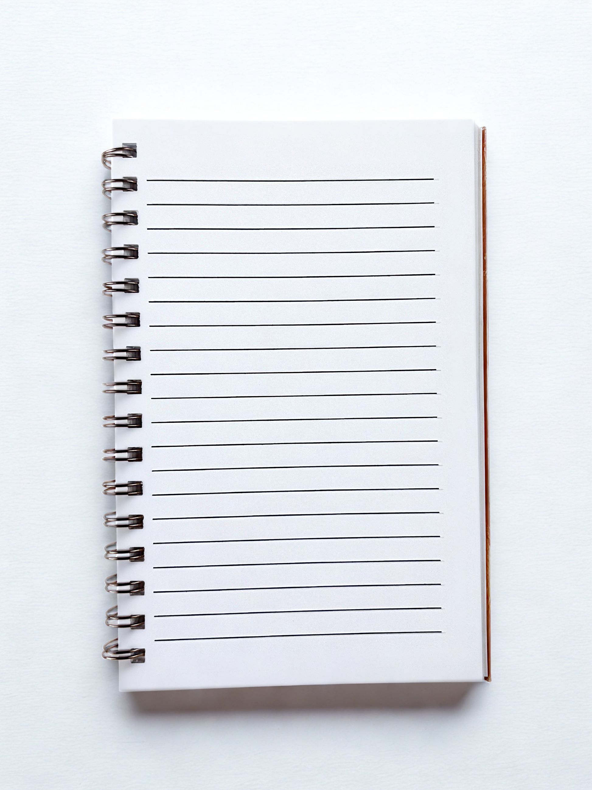 White notebook with lined pages on a white background