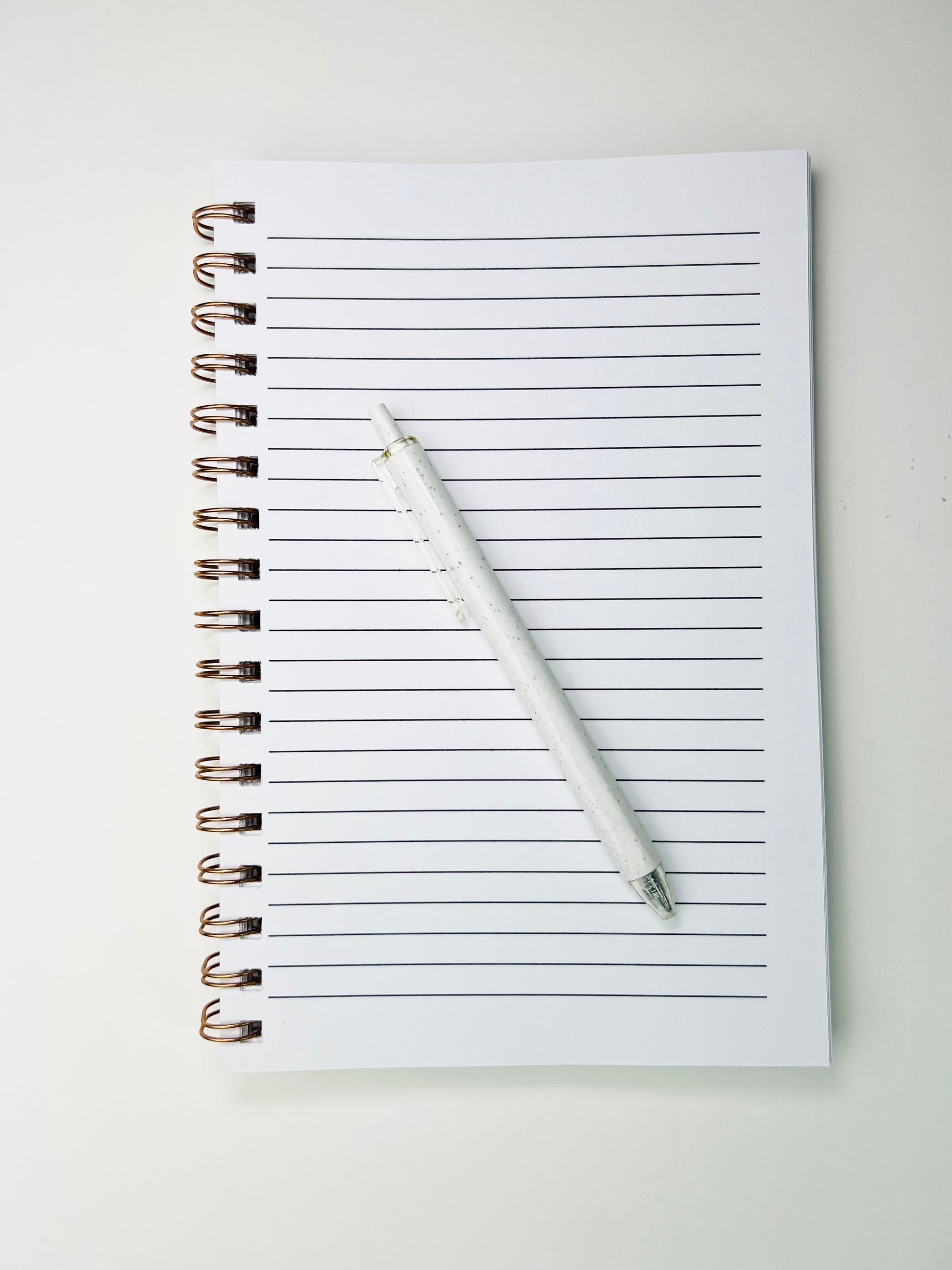Notebook with a pen on a white background