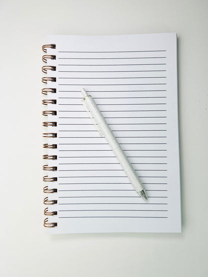Notebook with a pen on a white background