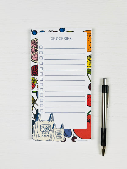 Super Market Magnetic Grocery List Notepad with fruit border and illustrated grocery bags with a pen for scale 