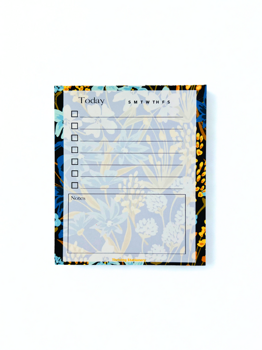 Navy Meadow Daily Planner Notepad with navy, blue, and gold floral border and daily checklist layout