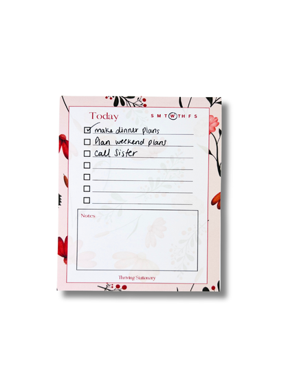 Pink Botanical Daily Planner Notepad with floral border, to-do list, and notes section with writing