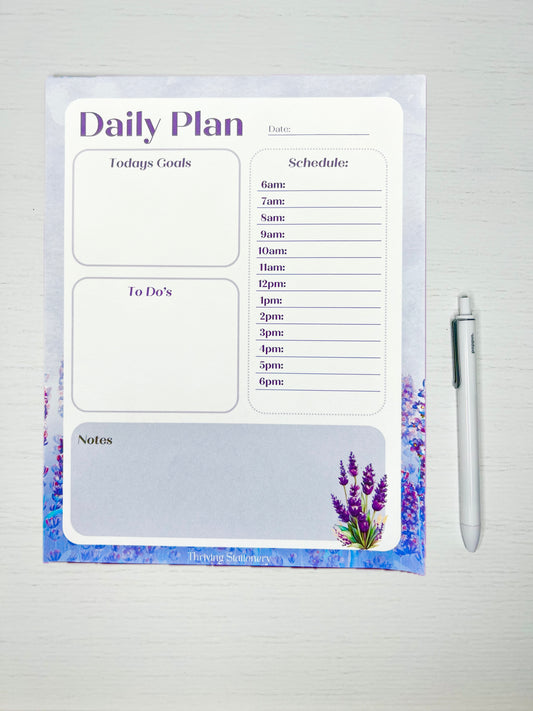 A planner notepad with a lavender theme, featuring a cover with lavender flowers and a pen beside it