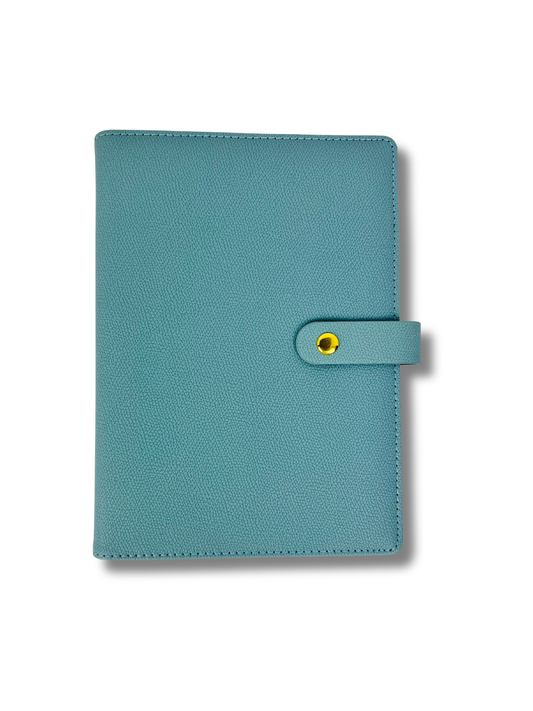 Teal planner cover with a yellow button on a white background