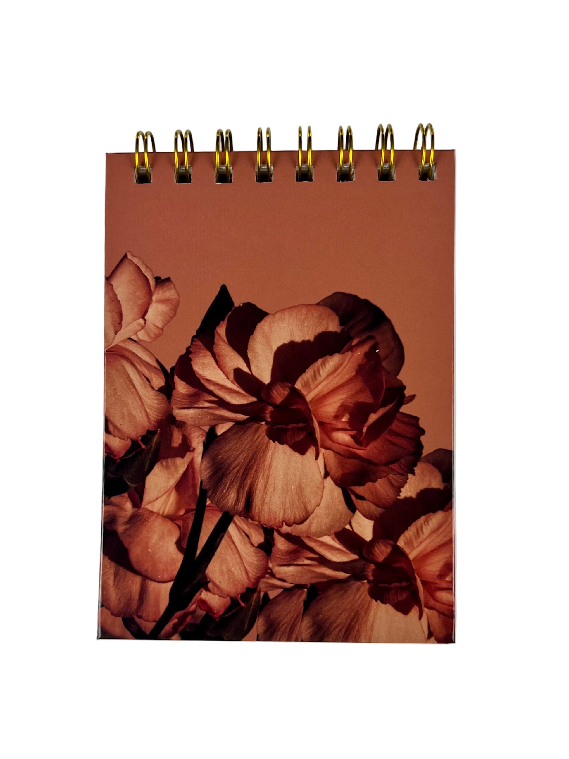 Notebook with floral design on a plain background