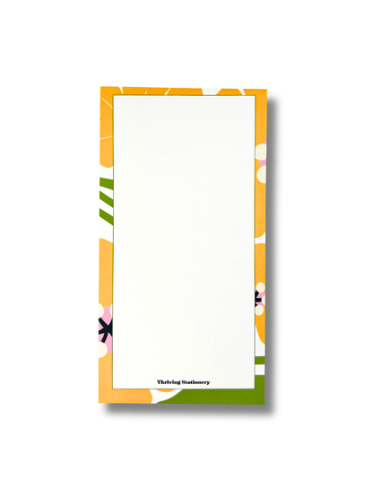 Notepad with colorful floral border on a white background