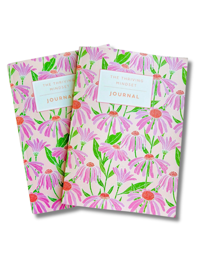 The Thriving Mindset Journal with pink floral cover and 90-day guided journaling layout