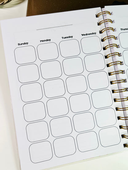 Weekly planner with labeled days of the week on a white surface