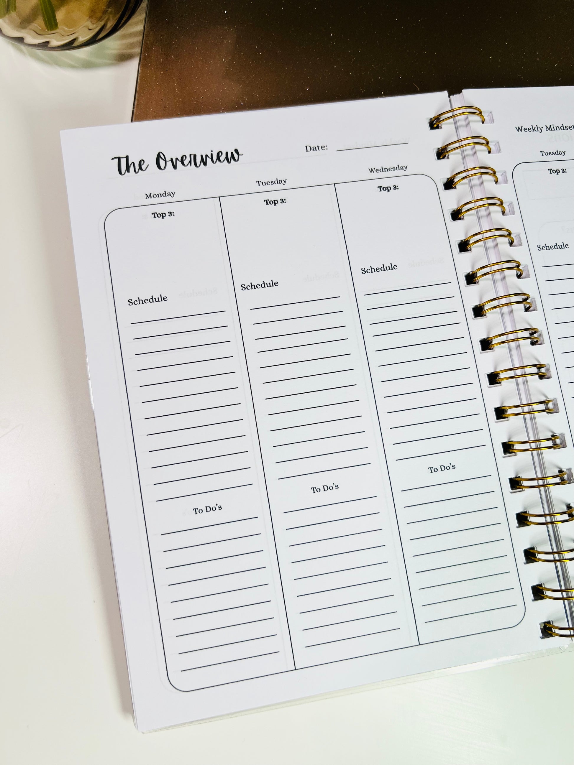Weekly planner with daily schedule and to-do list sections on a white surface.
